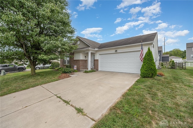 view of front of home with a front yard and a garage