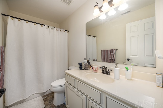 bathroom with tile patterned flooring, toilet, and vanity