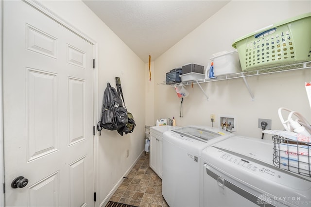 laundry room with tile patterned flooring, cabinets, and washing machine and clothes dryer