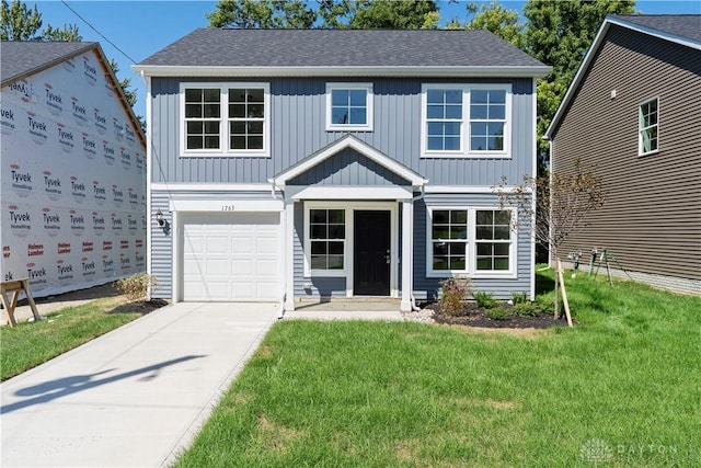 view of front of house featuring a front yard and a garage