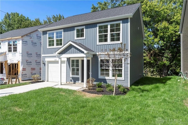 view of front of home with a front lawn and a garage