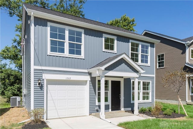 view of front of home featuring a garage and central air condition unit