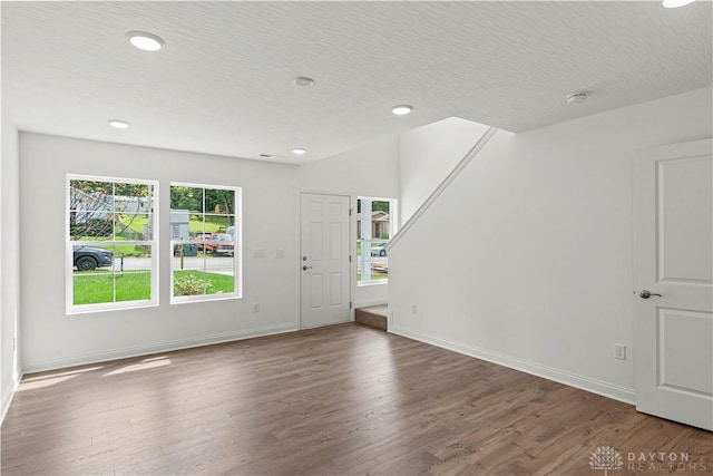 entrance foyer featuring wood-type flooring and a textured ceiling