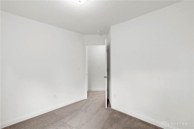 unfurnished room with light colored carpet