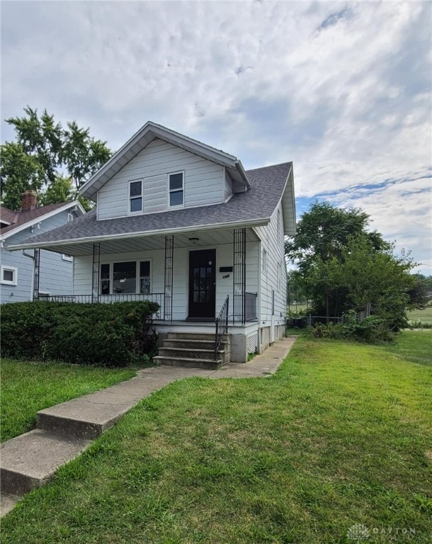 bungalow featuring a front yard and covered porch