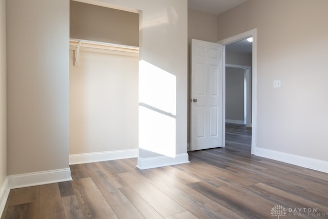 unfurnished bedroom with a closet and wood-type flooring