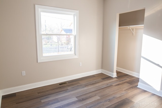 unfurnished bedroom with wood-type flooring and a closet