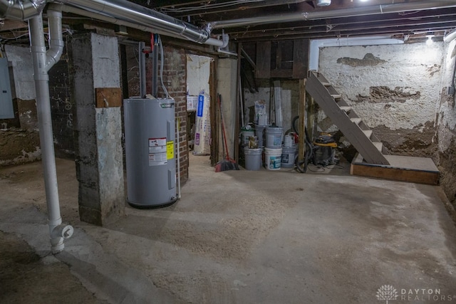 basement featuring water heater and electric panel