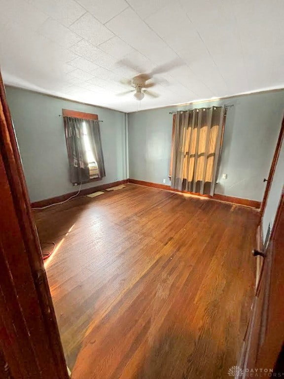 unfurnished room with hardwood / wood-style floors and ceiling fan