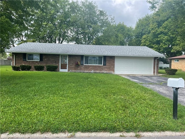 single story home with a front yard and a garage