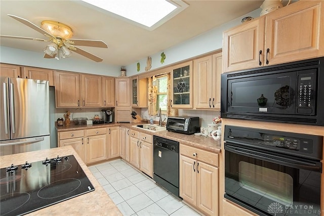 kitchen featuring black appliances, light brown cabinets, sink, backsplash, and light tile patterned flooring