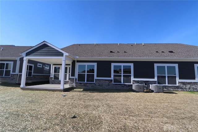 rear view of property featuring a patio and central air condition unit