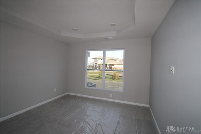 spare room featuring a tray ceiling