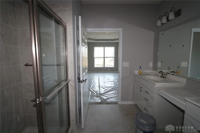 bathroom with tile patterned flooring, vanity, and an enclosed shower