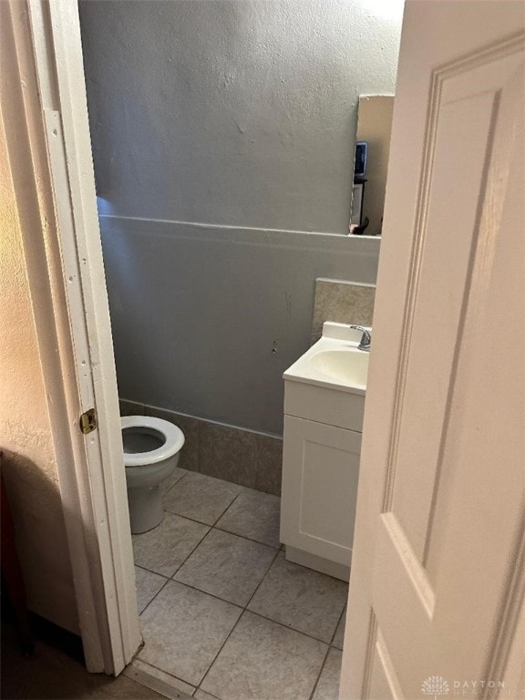 bathroom with tile patterned floors, toilet, and vanity