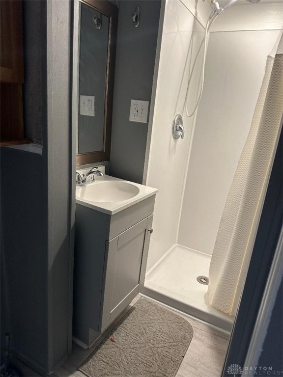 bathroom featuring vanity and a shower with shower curtain