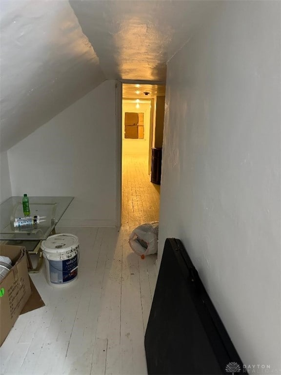 bonus room featuring lofted ceiling and hardwood / wood-style floors