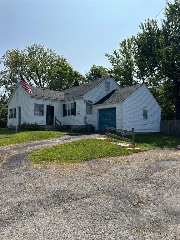 view of front of house featuring a garage and a front lawn