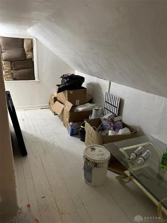 bonus room with lofted ceiling and hardwood / wood-style floors