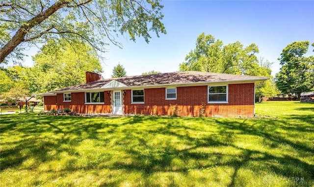 back of house with a lawn