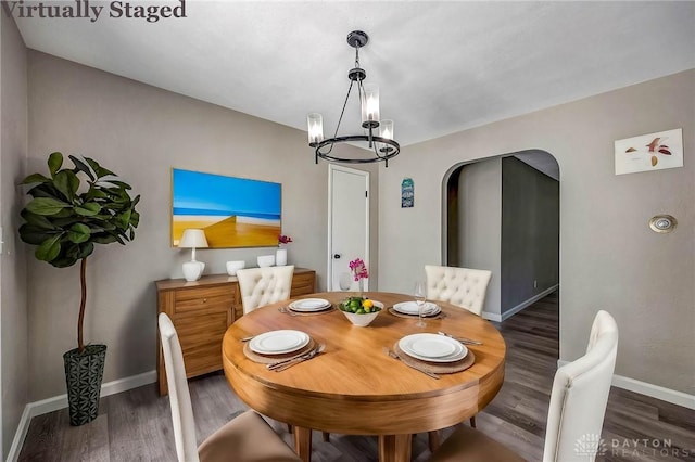 dining room featuring dark wood-type flooring and a chandelier