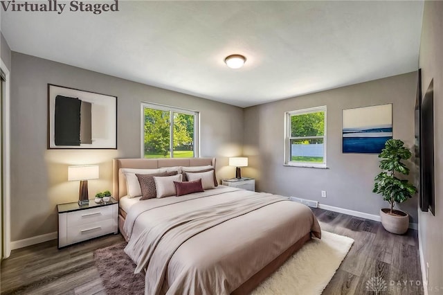 bedroom with dark wood-type flooring