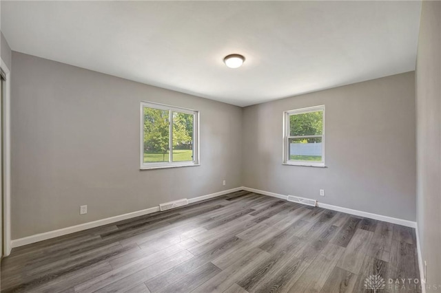 unfurnished room featuring wood-type flooring