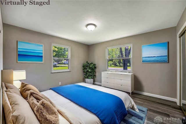 bedroom with dark hardwood / wood-style floors