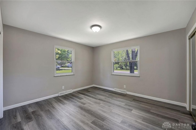 spare room with dark hardwood / wood-style floors