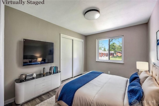 bedroom featuring wood-type flooring and a closet