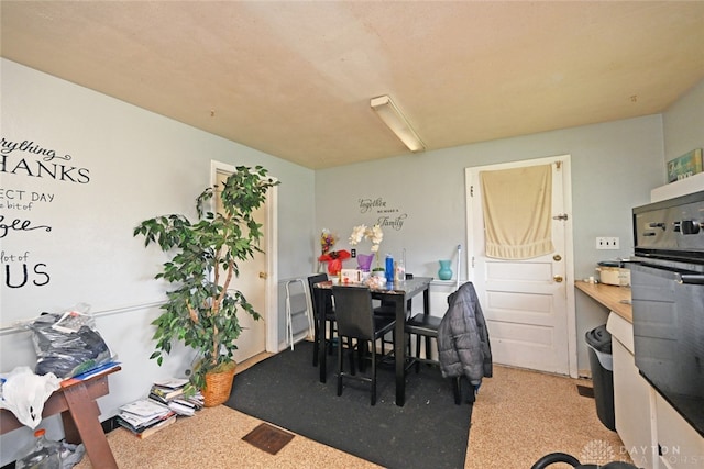 dining space with carpet flooring