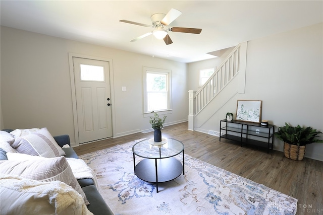 living room featuring dark hardwood / wood-style flooring and ceiling fan