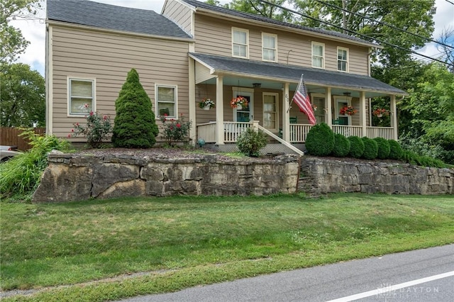 view of front facade with a front lawn and a porch