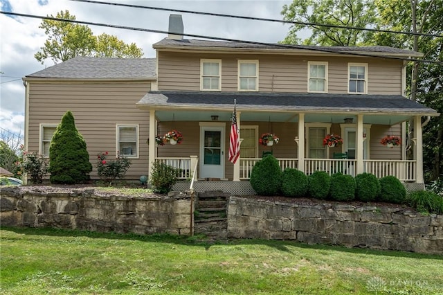 view of front of property featuring a porch and a front yard