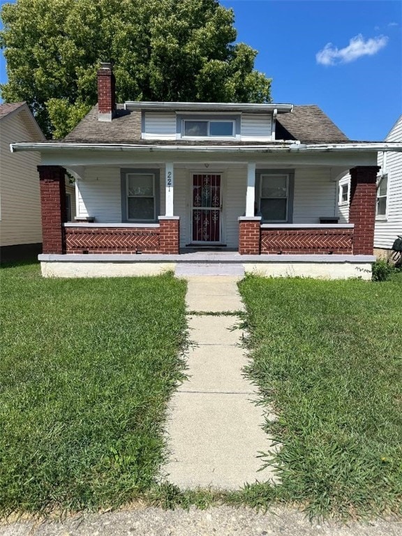 view of front of home featuring a porch and a front yard