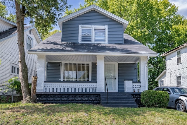 bungalow-style house featuring a porch and a front yard