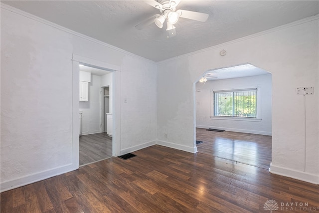 empty room featuring ornamental molding, ceiling fan, and dark hardwood / wood-style floors