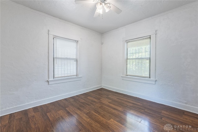 empty room with crown molding, ceiling fan, and dark hardwood / wood-style flooring