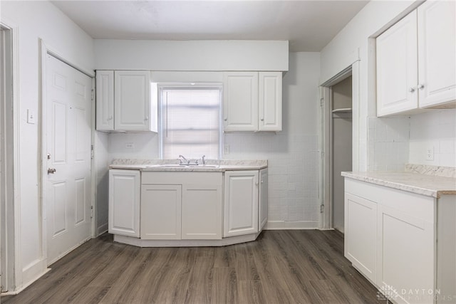 kitchen featuring white cabinets, dark hardwood / wood-style floors, and sink