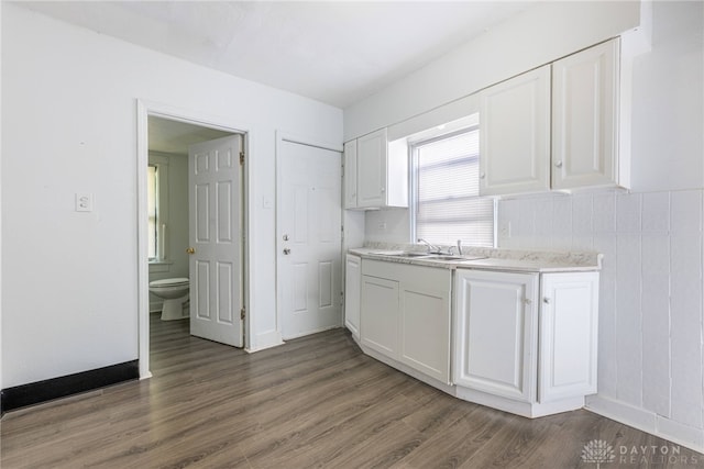 kitchen featuring white cabinets, dark hardwood / wood-style floors, and sink