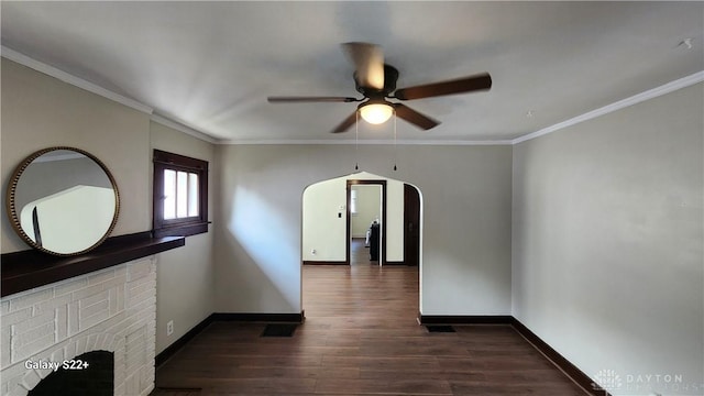 interior space featuring dark wood-style floors, arched walkways, crown molding, and baseboards