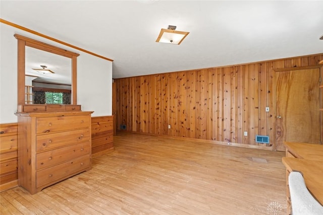 interior space featuring wood walls, visible vents, and wood finished floors