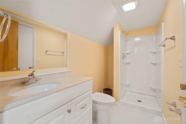 bathroom with a stall shower, vanity, toilet, and tile patterned floors