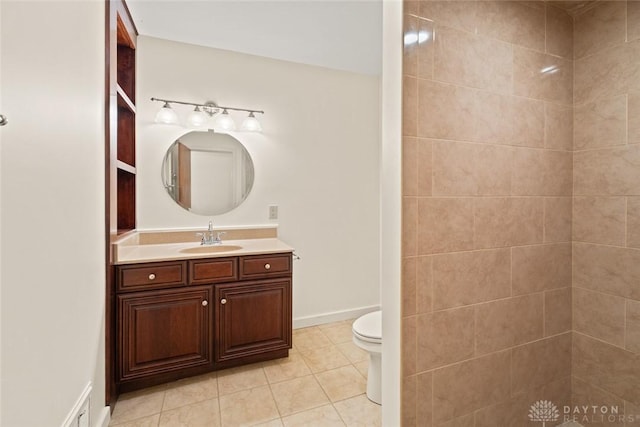 bathroom with toilet, a tile shower, vanity, tile patterned flooring, and baseboards