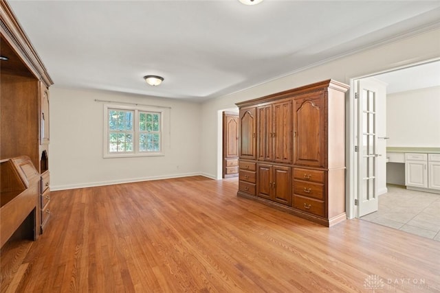 unfurnished bedroom with light wood finished floors and baseboards