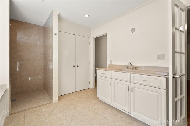 full bath with a walk in shower, ornamental molding, and vanity