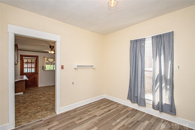 empty room featuring ceiling fan and light hardwood / wood-style flooring