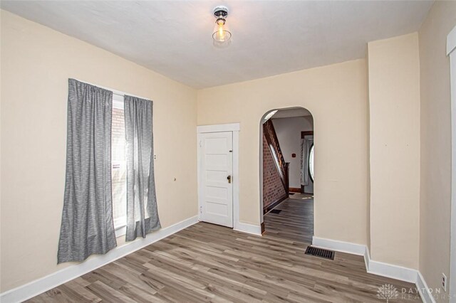 unfurnished room with hardwood / wood-style flooring