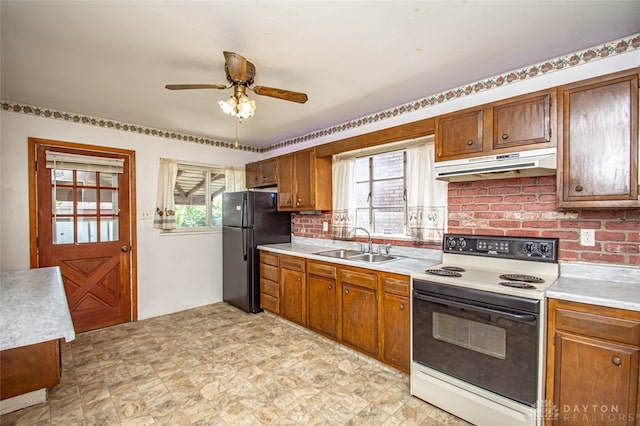 kitchen featuring electric range, black fridge, sink, backsplash, and ceiling fan