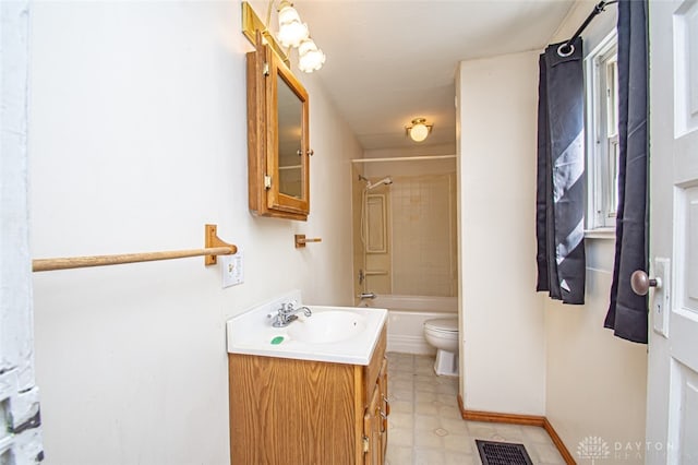 full bathroom with tiled shower / bath combo, vanity, and toilet